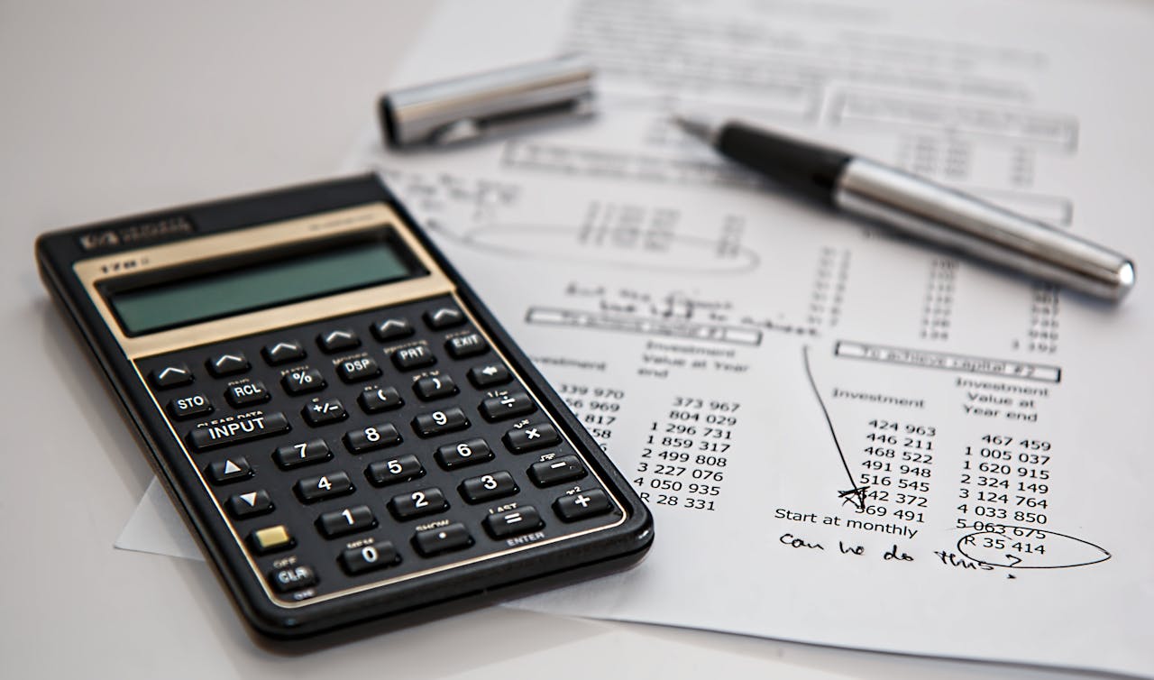 Home Close-up of financial documents with calculator and pen, ideal for business management themes.